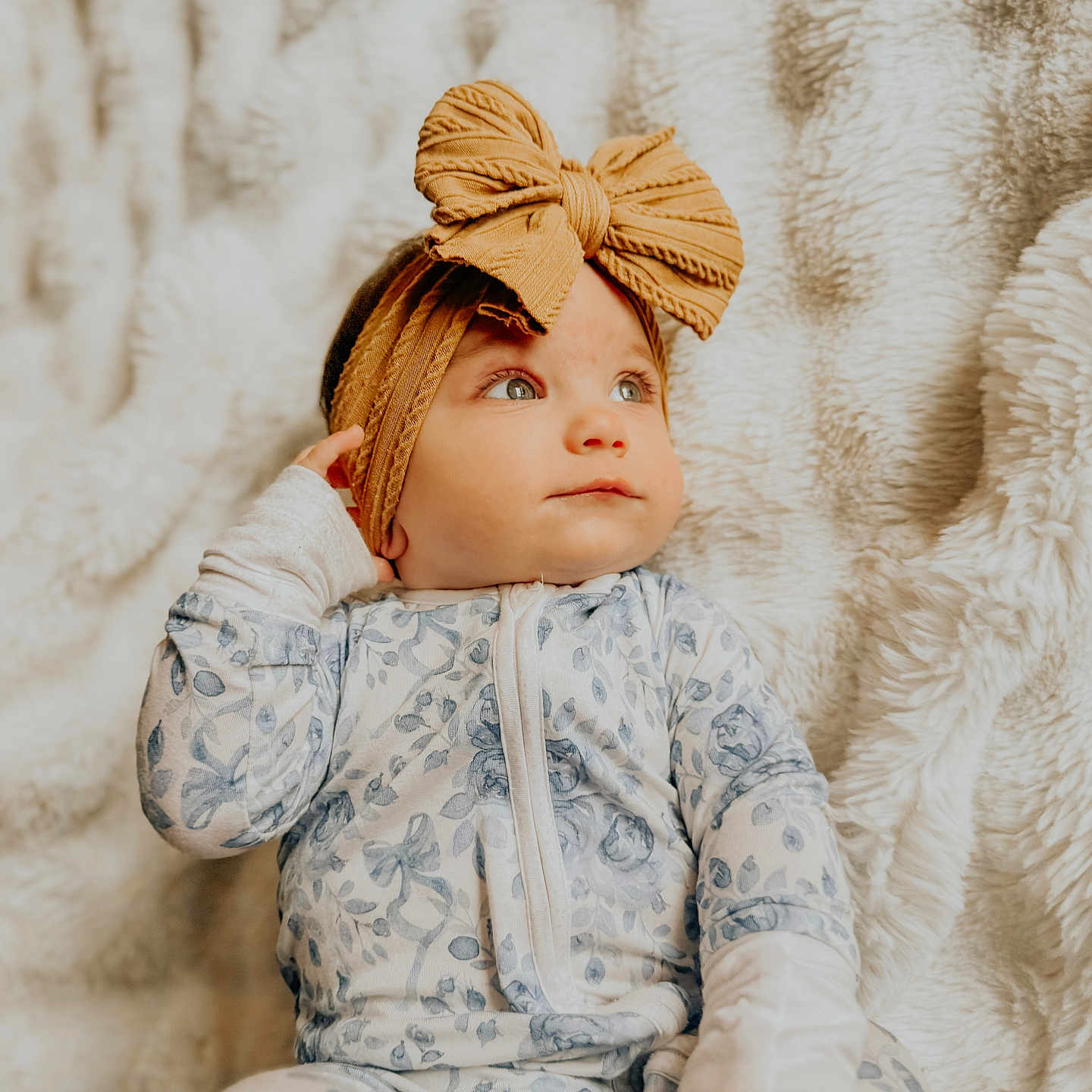 Brinley is registered to the contest to win money with this photo: baby, child, infant, headband, bow, floral_pajamas, blanket, soft_texture, portrait, face, cute, cozy, indoor, lying_down, hand, expression, young_child, closeup, sleepwear, comfort