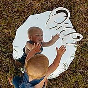 Beau joined the competition — help win amazing prizes! toddler, child, mirror, reflection, grass, outdoor, denim, overalls, first_birthday, sign, playing, happy, baby, cute, hands, blond_hair, nature, summer, portrait, exploring