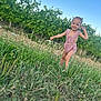blue_sky, child, daytime, field, grass, greenery, happy, nature, outdoor, person, pigtails, pink_romper, plants, playful, portrait, smiling, summer, sunny, toddler, wildflowers