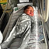 Wysdom is registered to the contest to win money with this photo: baby, newborn, hospital, bassinet, blanket, pacifier, clothing, onesie, sleeping, infant, person, face, bed, hospital_room, medical_equipment, cute, peaceful, indoors, child, resting