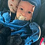 baby, pacifier, blue_clothing, hood, polka_dots, plush_toy, car_seat, child, infant, cute, soft_toy, cozy, wrapped, young_child, portrait, indoors, seatbelt, face, looking, adorable