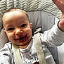 baby, child, face, messy_face, berry_stains, high_chair, harness, grey_shirt, reaching_hand, smiling, happy, indoor, cushion, fabric, closeup, portrait, infant, cute, expression, skin