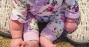 Mia is registered to the contest to win money with this photo: baby, bow, carpet, child, cushion, cute, floor, floral_clothing, happy, headband, home, indoor, infant, onesie, person, pink, portrait, purple, sitting, smiling