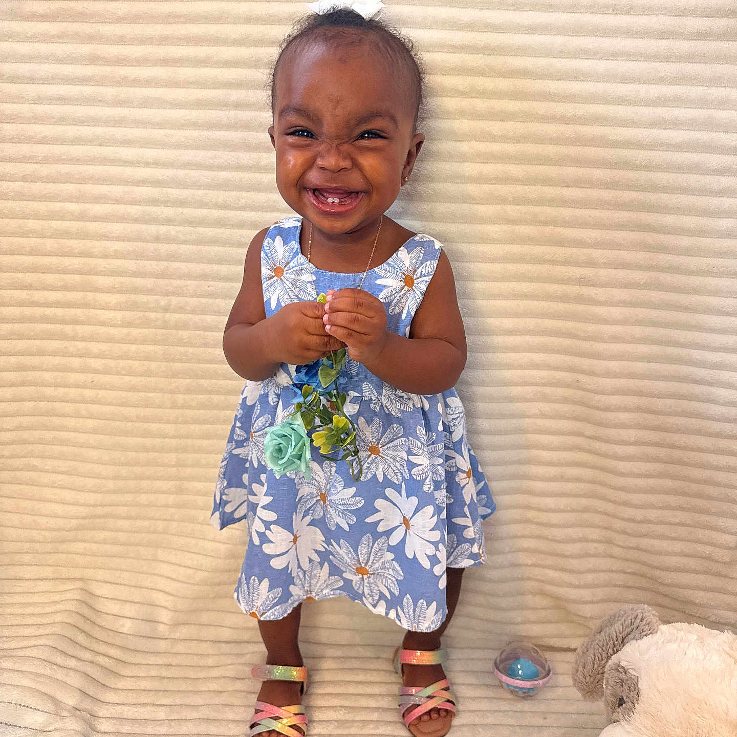 Jaydee joined the competition — help win amazing prizes! accessory, background, blue, child, cute, dress, floral_pattern, flower, happy, indoors, joyful, person, plush_toy, sandals, smiling, standing, teddy_bear, toddler, toy, young_child