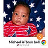baby, infant, child, portrait, face, eyes, awake, lying_down, red_shirt, blue_blanket, stars, indoor, webpage, screenshot, contest, website, mobile_screen, photography, person, cute