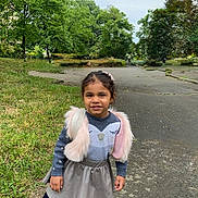 Zendaya participe au concours pour gagner de l'argent avec cette photo : casual_clothing, child, daytime, girl, grass, hairclip, happy, nature, outdoor, park, person, playful, sidewalk, skirt, smile, sneakers, sweater, trees, vest, young