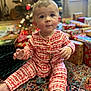 Maverick joined the competition — help win amazing prizes! baby, child, pajamas, holiday, christmas_tree, presents, gift_wrapping, carpet, indoors, pacifier, patterned_clothing, festive, cute, sitting, curious, decorations, holiday_season, young_child, face, blue_eyes