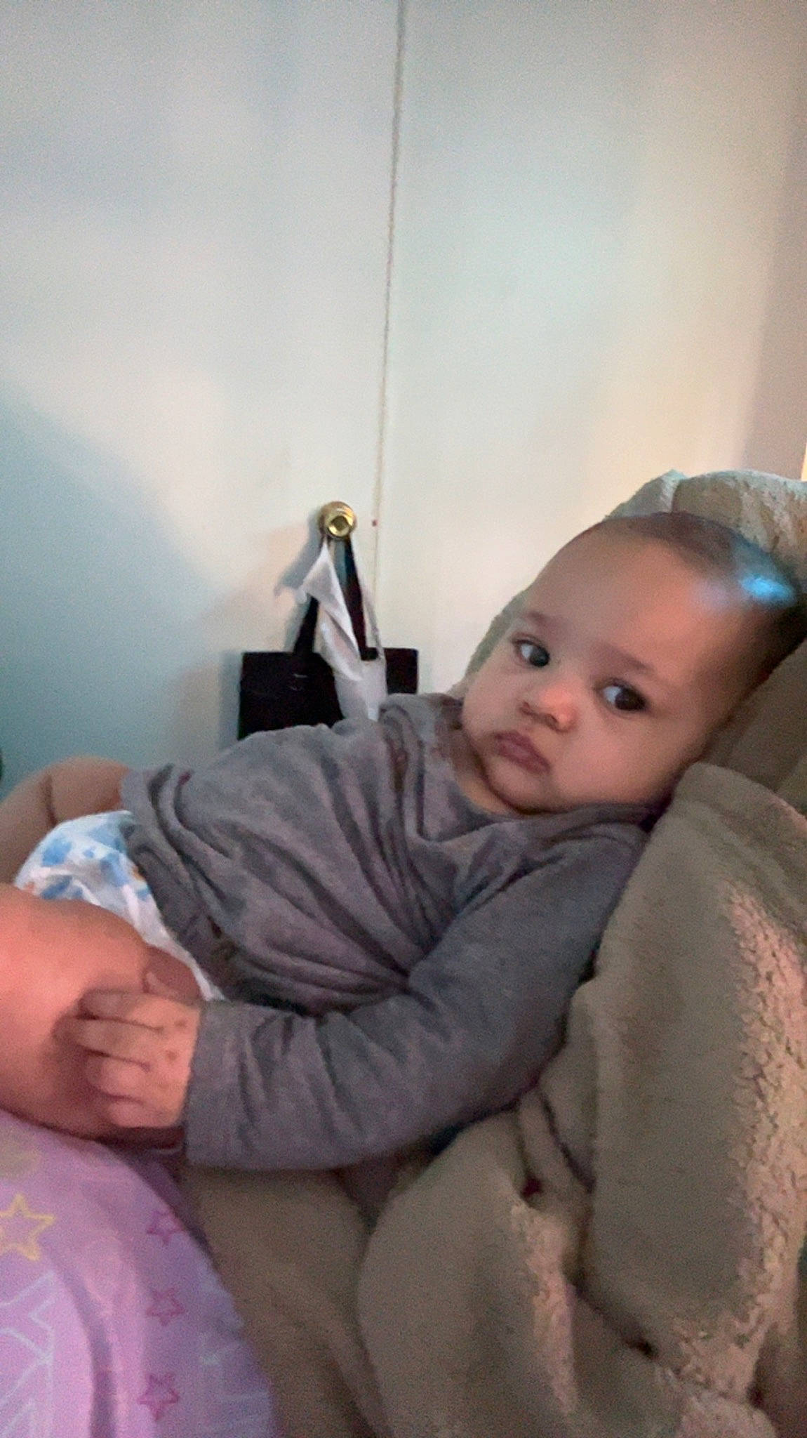 Marlee is registered to the contest to win money with this photo: abdomen, baby, baby_toddler_clothing, cheek, child, comfort, elbow, eye, flooring, human_leg, knee, leg, linens, nose, person, room, shoulder, sitting, skin, toddler