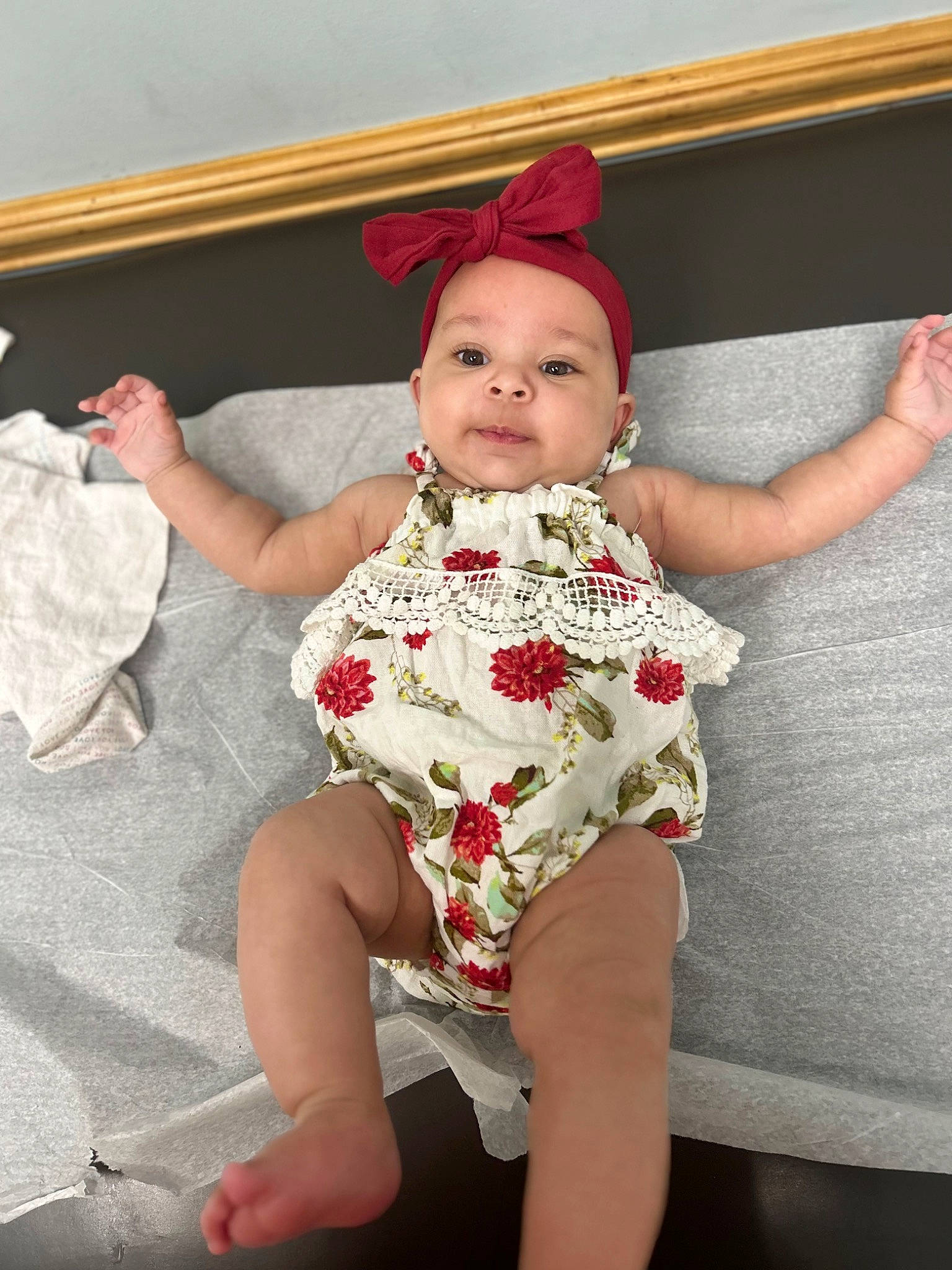 Marlee is registered to the contest to win money with this photo: baby, baby_toddler_clothing, carmine, chin, eye, face, fun, happy, head, human_body, human_leg, knee, lap, lip, neck, pattern, person, sleeve, smile, thigh