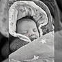 Kivers participe au concours pour gagner de l'argent avec cette photo : baby, sleeping, blanket, star_pattern, cushion, infant, cozy, face, closeup, carrying_bag, newborn, soft_texture, peaceful, child, portrait, indoors, head_covering, wrapped, resting, cute