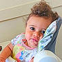 Antony is registered to the contest to win money with this photo: toddler, child, high_chair, bib, curly_hair, face, indoor, expression, seat, clothing, comfort, baby, person, cute, portrait, feeding, furniture, young_child, home, skin