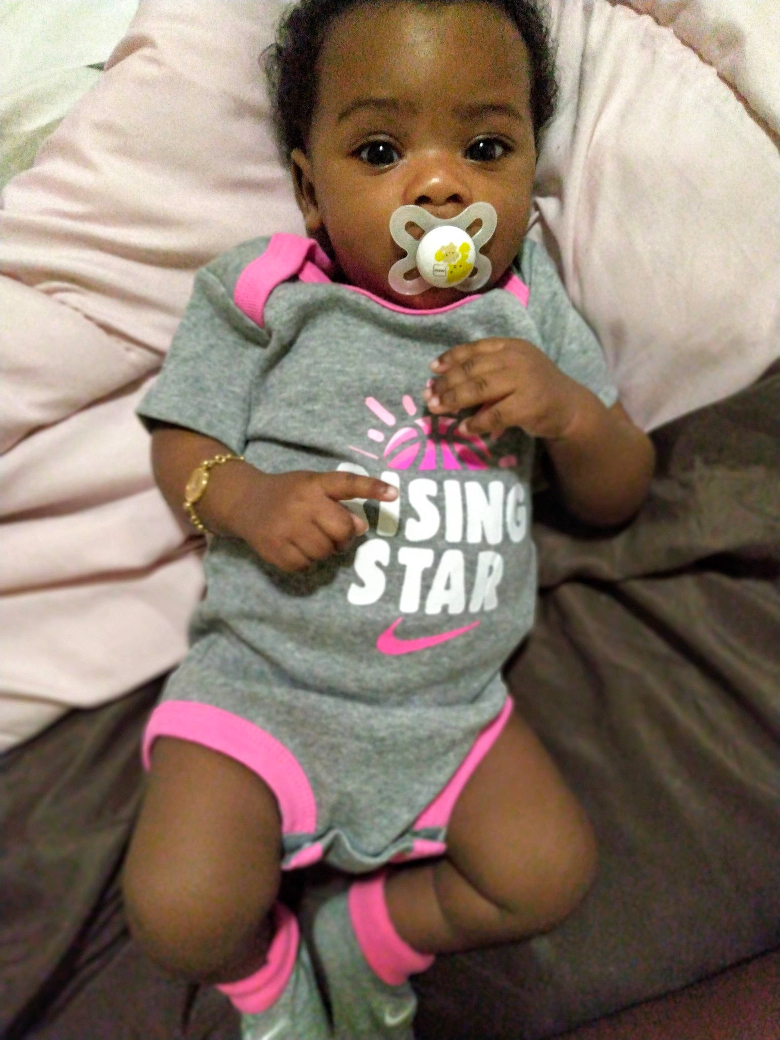 Mi'Amor is registered to the contest to win money with this photo: arm, baby, baby_toddler_clothing, black, cheek, clothing, finger, gesture, happy, joint, lip, mouth, nose, people, person, pink, shorts, skin, sleeve, t_shirt