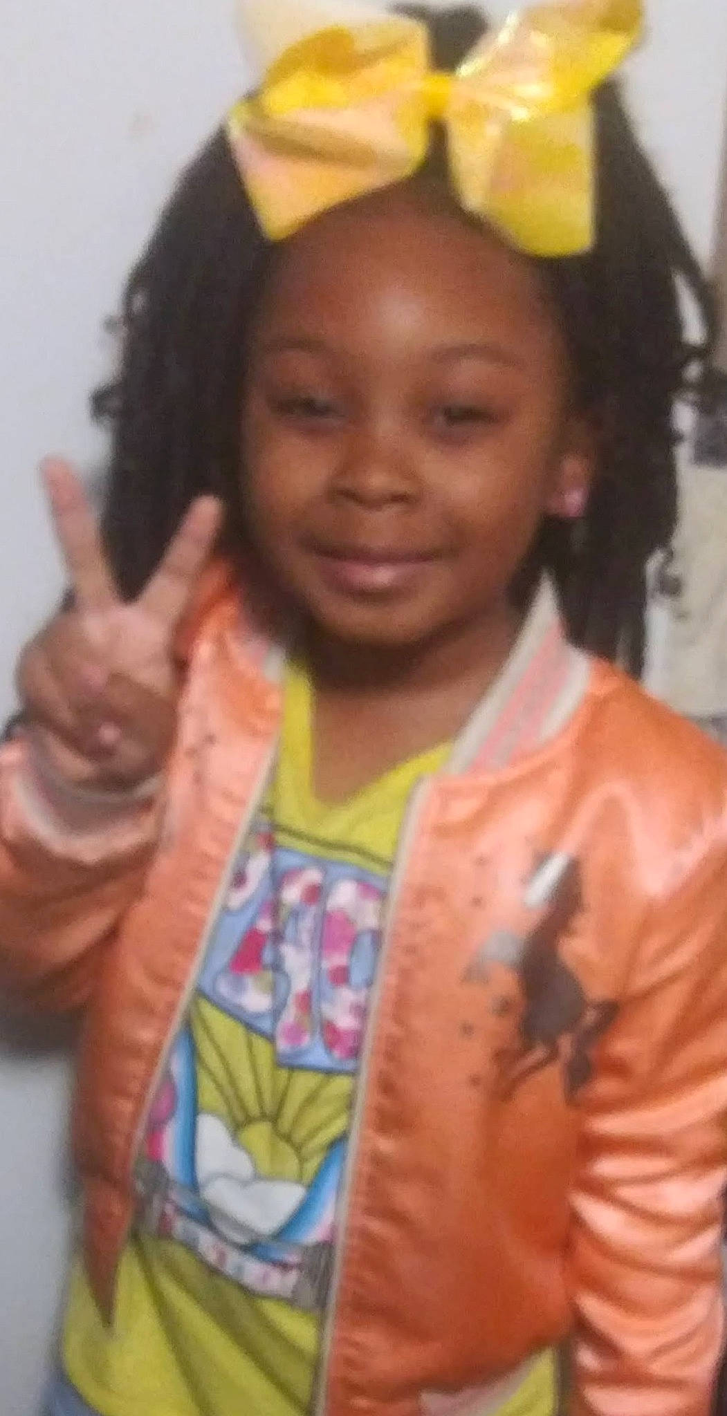 Olivia is registered to the contest to win money with this photo: black_hair, cheek, child, cool, event, eyebrow, facial_expression, finger, forehead, fun, gesture, happy, head, jewellery, joy, necklace, organ, person, skin, sleeve