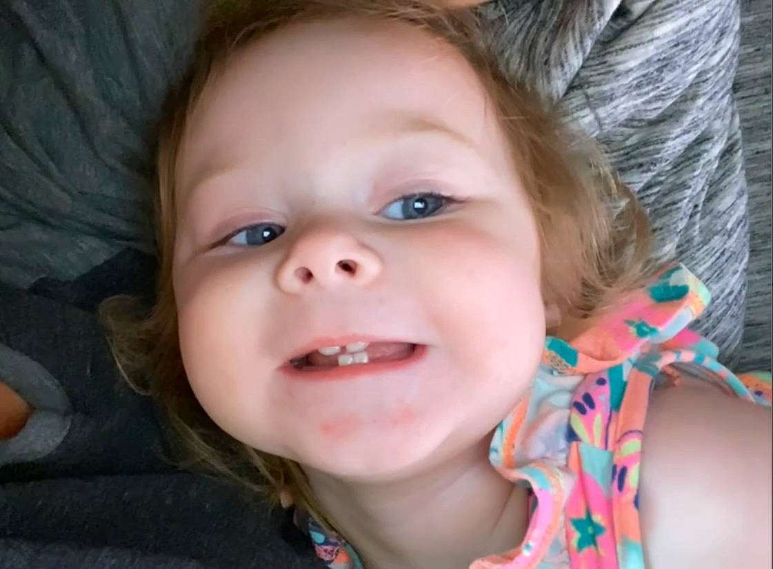 Bailey is registered to the contest to win money with this photo: cheek, cool, ear, eye, eyebrow, eyelash, finger, forehead, happy, head, iris, jaw, joy, lip, mouth, nose, person, skin, smile, toddler