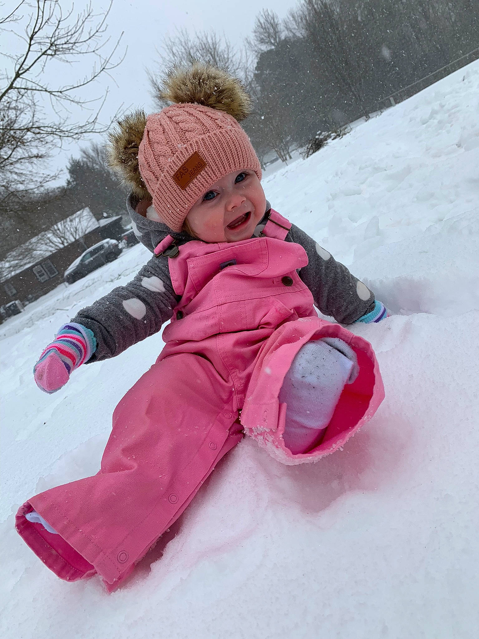 Bailey joined the competition — help win amazing prizes! baby_toddler_clothing, child, freezing, fun, geological_phenomenon, happy, headwear, jacket, leisure, magenta, parka, person, pink, recreation, sky, sled, sledding, slope, smile, snow