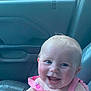 Raylynn is registered to the contest to win money with this photo: baby, child, smiling, happy, car_seat, pink_dress, watermelon_pattern, face, blue_eyes, infant, inside_car, seat, window, door_panel, leather_seat, crack, young_child, portrait, cute, cheerful
