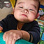 Kingsley is registered to the contest to win money with this photo: baby, child, hand, face, indoor, playpen, toy, colorful, furniture, clothing, expression, curious, soft, cheeks, candid, young_child, infant, holding, wristband, floor_mat
