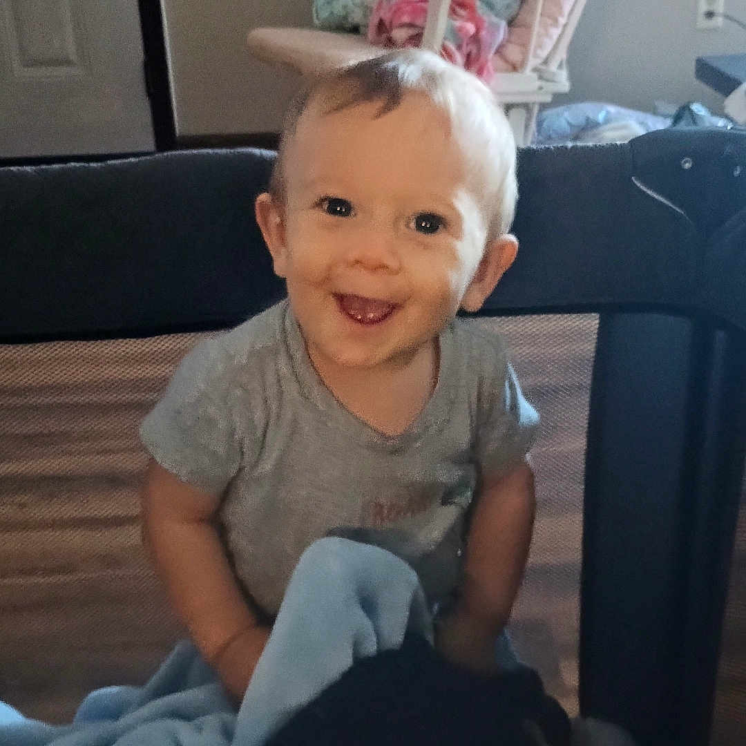 Christian Faircloth joined the competition — help win amazing prizes! baby, blanket, chair, child, clothing, cozy, cushion, face, furniture, happy, head, home, indoor, light, person, playpen, room, smile, toddler, young_child