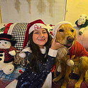 Jolie joined the competition — help win amazing prizes! girl, dog, golden_retriever, santa_hat, christmas, holiday, smiling, plush_toy, snowman, couch, blanket, indoor, festive, child, pet, celebration, costume, happy, home, family