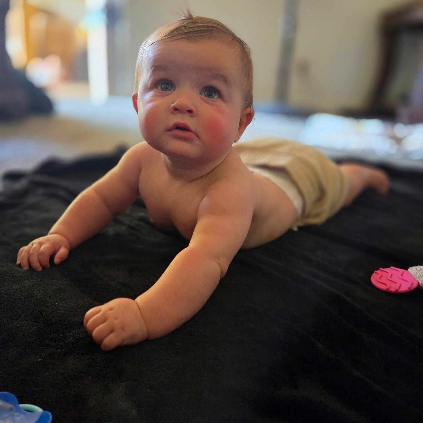 Sam joined the competition — help win amazing prizes! arm, baby, blanket, blurred_background, child, curious, cute, expression, face, floor, hand, indoor, infant, light, pacifier, room, skin, soft, toy, tummy_time