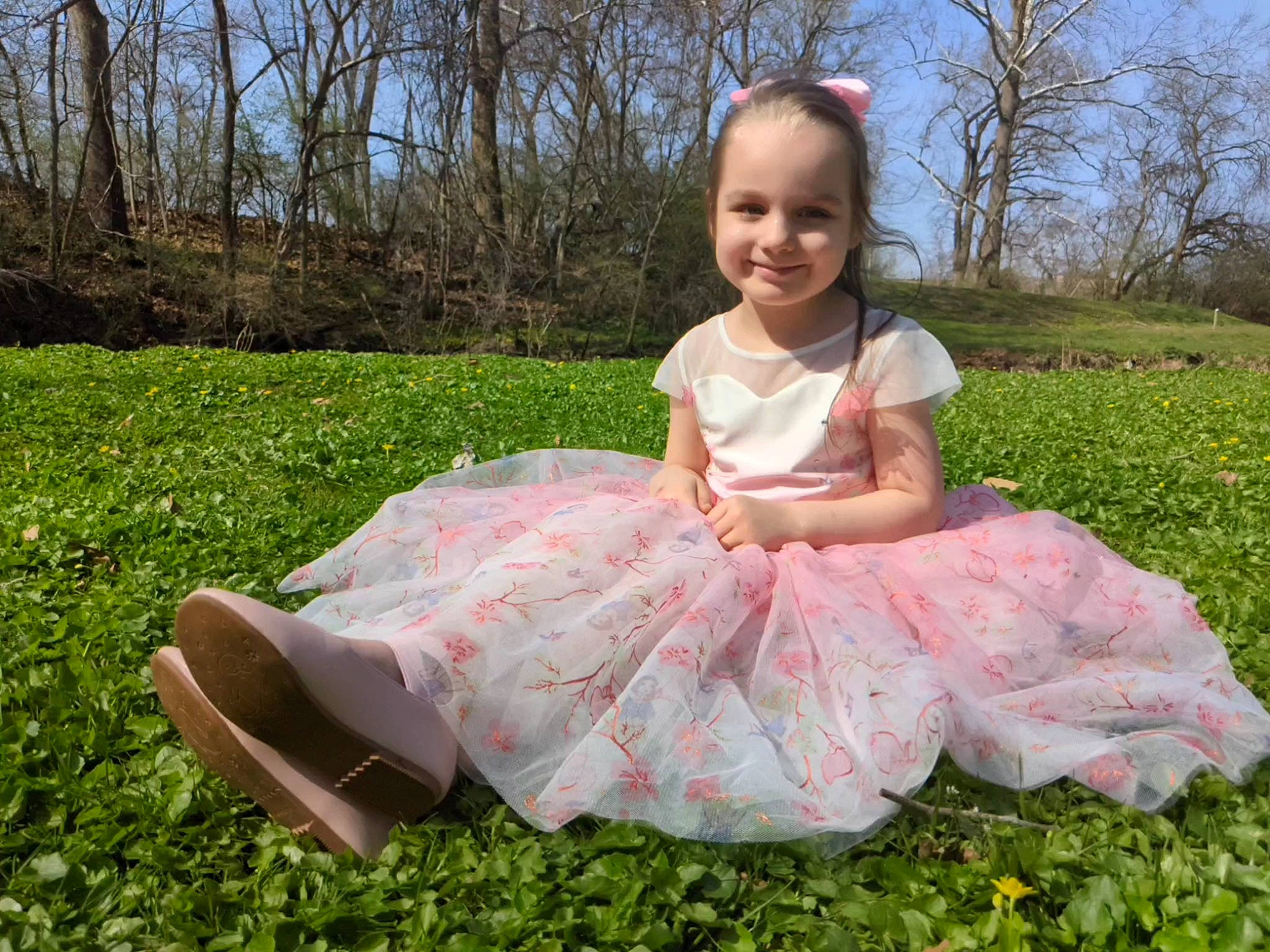 Syaris is registered to the contest to win money with this photo: baby_toddler_clothing, blond, dress, event, face, fun, grass, grassland, happy, joy, lawn, magenta, meadow, people_in_nature, person, pink, plant, ruffle, sky, smile