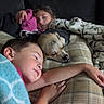 child, dog, sleeping, blanket, couch, pillow, indoors, rest, comfort, cozy, nap, family, relaxation, peaceful, warm, home, friendship, portrait, casual, happy
