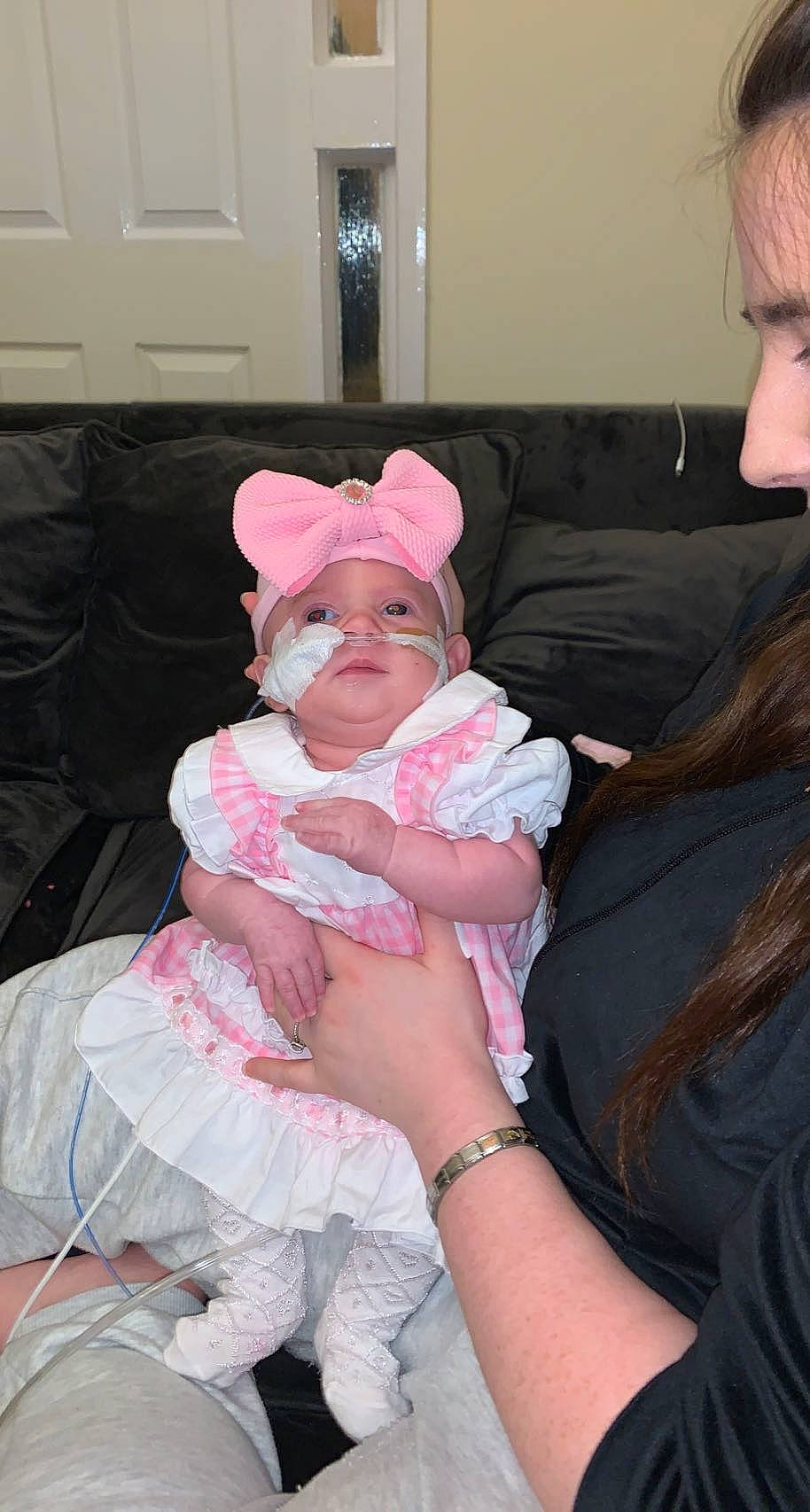 Isabella-rose is registered to the contest to win money with this photo: baby, baby_toddler_clothing, cap, cheek, child, comfort, couch, event, eye, face, fun, headwear, interaction, lap, magenta, mouth, person, pink, room, sitting