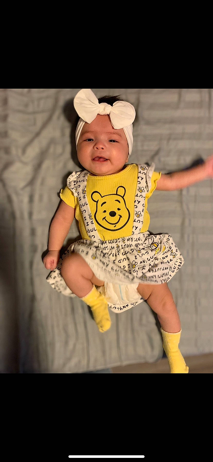 Maddie is registered to the contest to win money with this photo: baby, baby_products, baby_toddler_clothing, cap, cheek, child, eye, finger, flash_photography, happy, hat, headgear, headwear, pattern, person, photograph, sitting, sleeve, smile, t_shirt