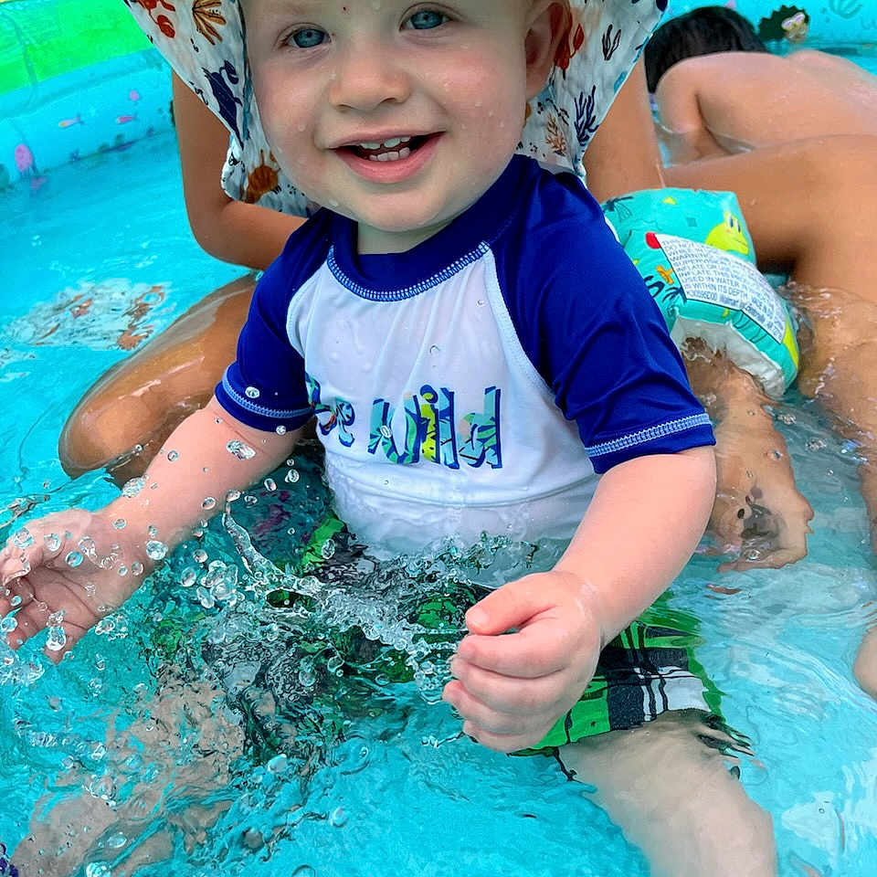 Christopher is registered to the contest to win money with this photo: baby, clothing, face, hat, head, leisureactivities, lifejacket, person, photography, pool, portrait, shorts, sport, summer, swimming, swimmingpool, t_shirt, vest, water, watersports