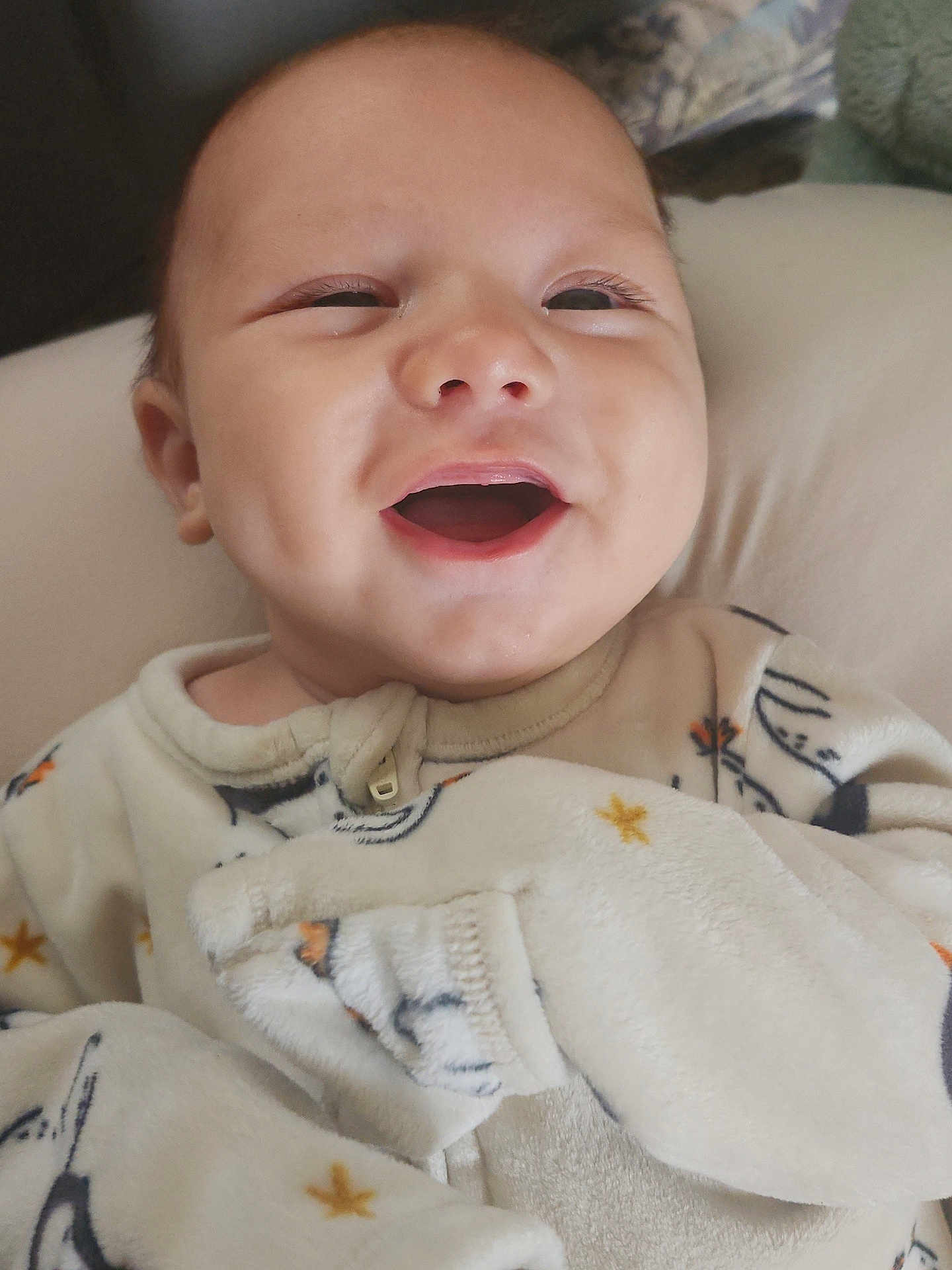 Wayne is registered to the contest to win money with this photo: baby, smiling, pajamas, infant, face, happy, cute, child, portrait, sleepwear, closeup, cozy, expression, young, person, indoors, soft, warm, cheerful, newborn