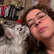 Nala joined the competition — help win amazing prizes! affection, books, cat, close_up, cozy, curly_hair, decor, face, giraffe_painting, glasses, gray_cat, home, indoor, nuzzling, pet, portrait, sentimental_message, shelf, wall_art, woman