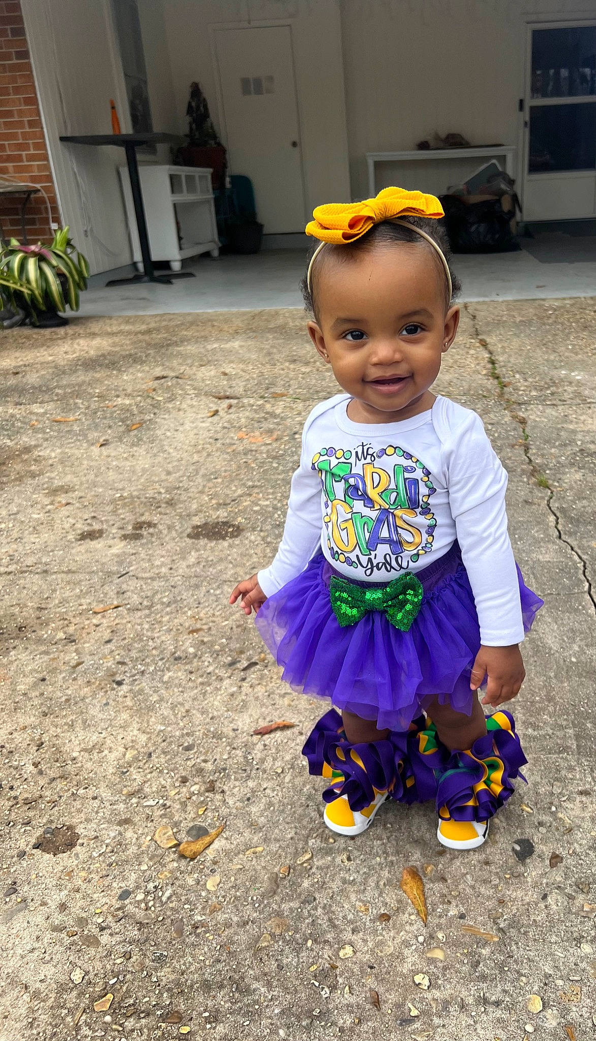 Mila is registered to the contest to win money with this photo: baby, baby_toddler_clothing, child, costume, door, electric_blue, fun, grass, happy, houseplant, joy, magenta, pattern, person, plant, purple, recreation, sandal, smile, t_shirt