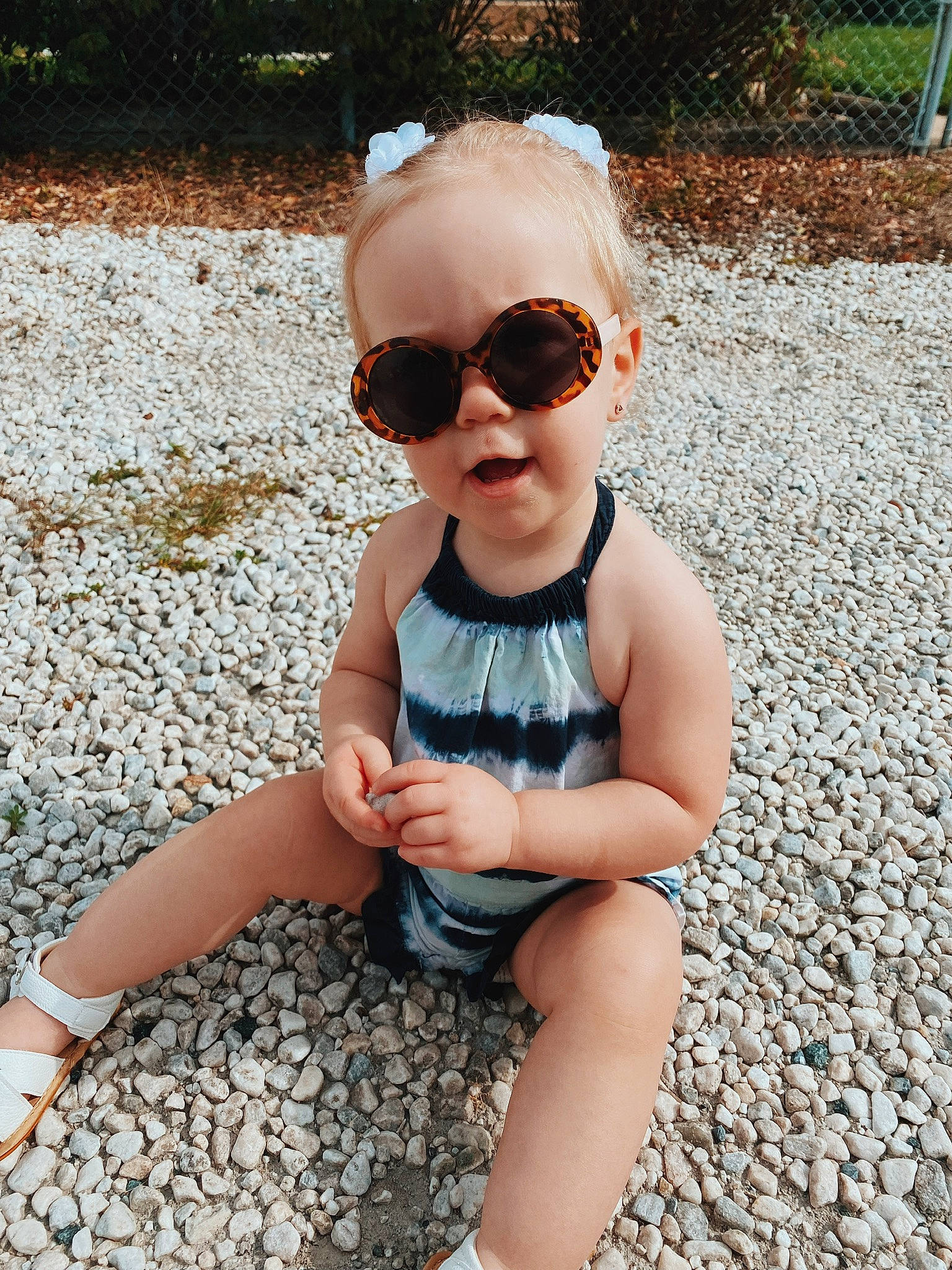 Hensley is registered to the contest to win money with this photo: baby, baby_toddler_clothing, child, cool, electric_blue, eyewear, fun, goggles, grass, happy, human_leg, leisure, person, plant, sitting, sleeve, sunglasses, thigh, toddler, vision_care