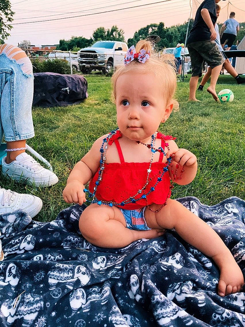 Hensley is registered to the contest to win money with this photo: baby, baby_toddler_clothing, blue, chair, cool, fun, grass, happy, leg, leisure, person, photograph, plant, shoe, shorts, sky, sneakers, thigh, tire, toddler