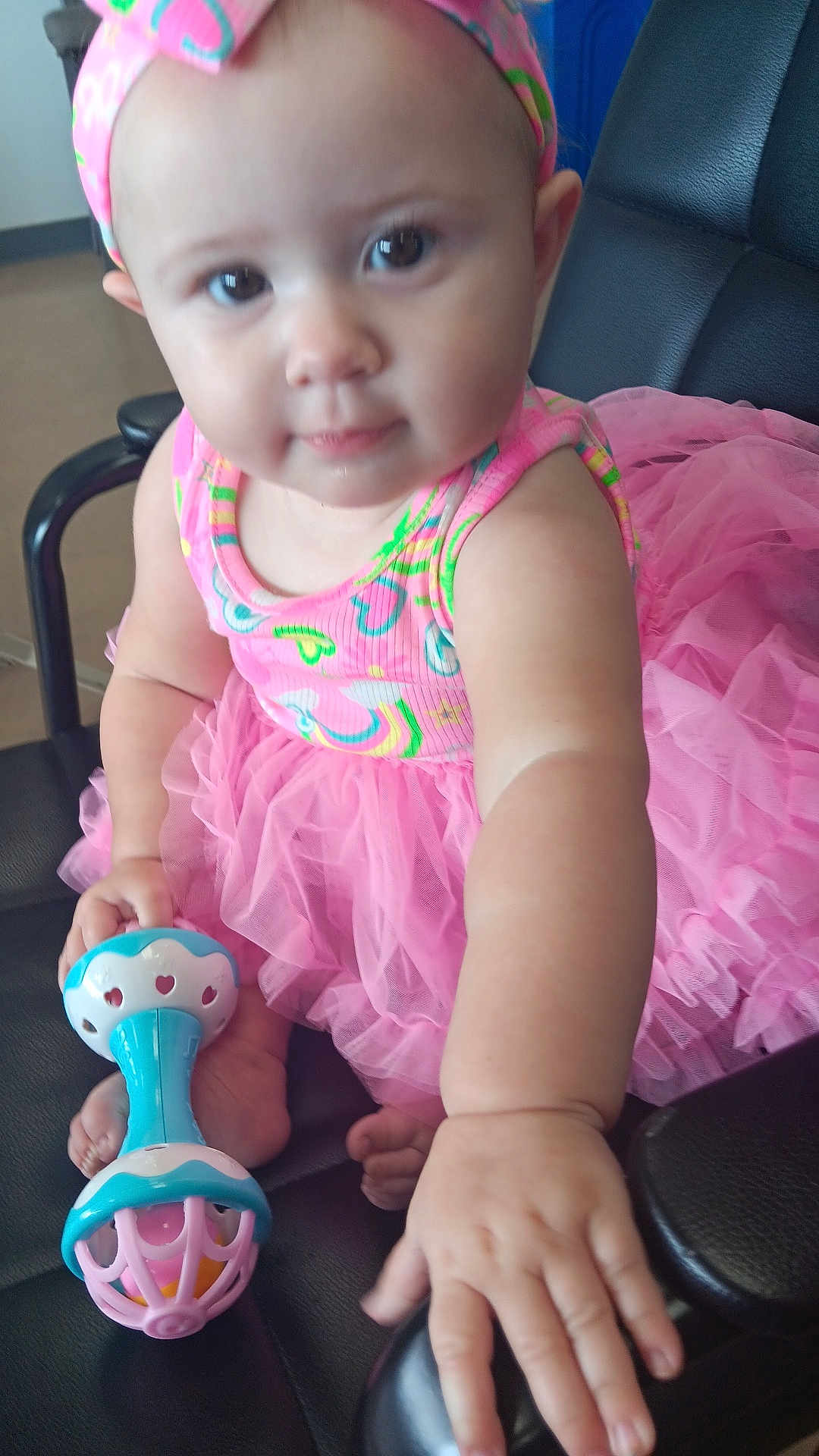 Heavenly is registered to the contest to win money with this photo: baby, child, tutu, pink_clothing, headband, rattle, toy, chair, leather, hand, foot, cute, indoor, portrait, infant, colorful, playful, sitting, person, young
