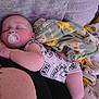 baby, sleeping, pacifier, blanket, couch, infant, comfort, rest, child, soft, cozy, giraffe_pattern, relaxation, indoor, cute, peaceful, person, clothing, nap, toddler