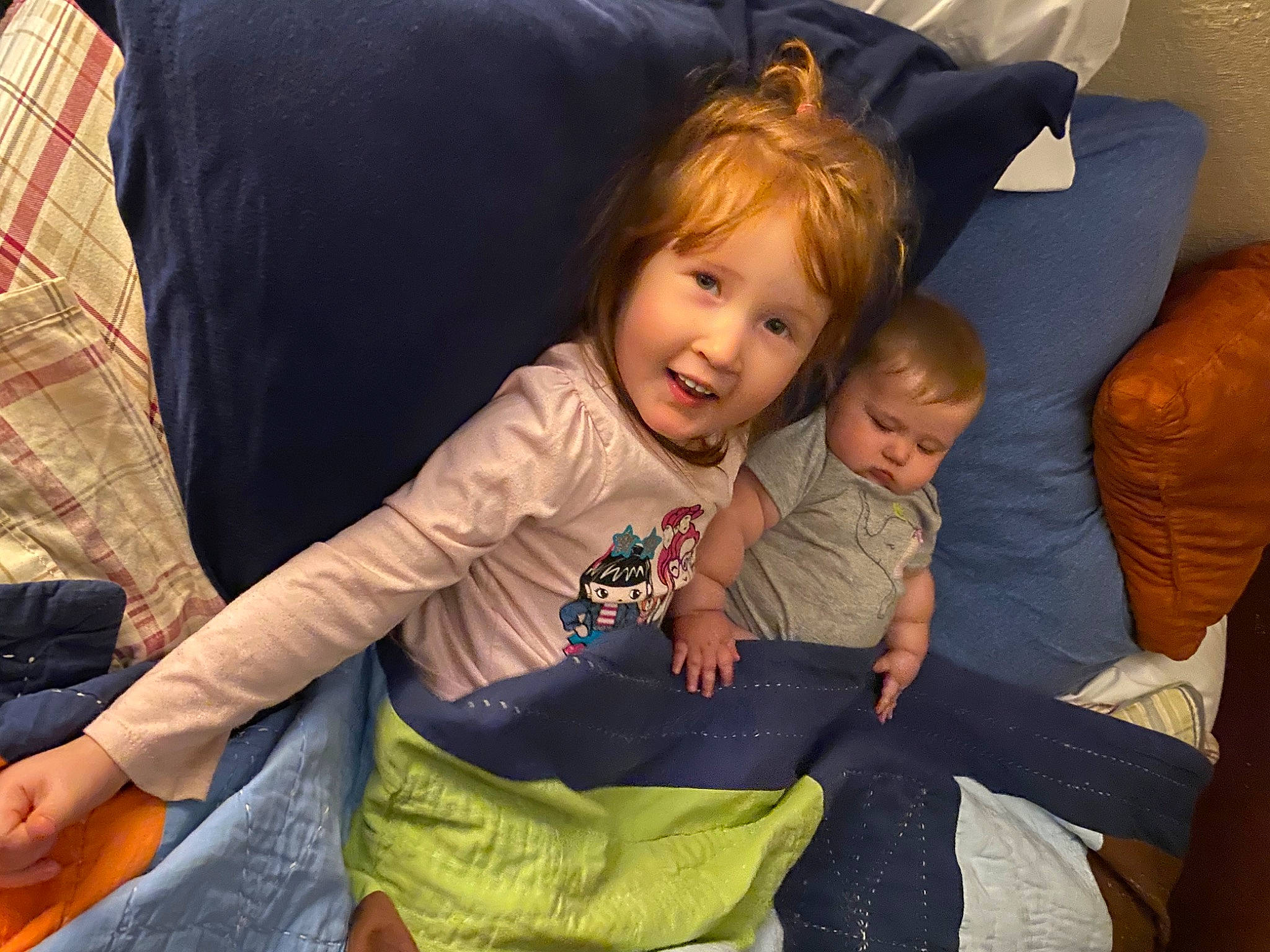 Raelynn is registered to the contest to win money with this photo: baby, baby_toddler_clothing, child, comfort, couch, event, facial_expression, fun, happy, lap, leisure, living_room, person, play, room, sharing, sitting, smile, tartan, toddler