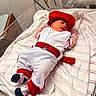 Jericho joined the competition — help win amazing prizes! newborn, baby, infant, bed, blanket, hospital, clothing, cap, sleeping, footwear, socks, red, white, striped, person, cute, resting, indoors, crib, belt