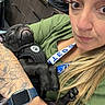 Onyx is registered to the contest to win money with this photo: affection, arm, black_dog, casual, closeup, clothing, cute, dog, drawer, expression, face, holding, indoor, long_hair, pet, puppy, sleeping, tattoo, watch, woman