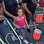 child, girl, smile, lantern, street, people, adult, summer, festival, celebration, curly_hair, pink_shirt, denim_shorts, sneakers, walking, hand, outdoor, evening, group, fun
