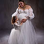Meylia a rejoint le concours — aidez-le/la à gagner de superbes lots ! pregnant_woman, child, studio, portrait, white_dress, elegant, mother_and_daughter, love, tender_moment, gown, long_dress, female, family, holding_hands, smile, curly_hair, headband, soft_lighting, neutral_background, tulle