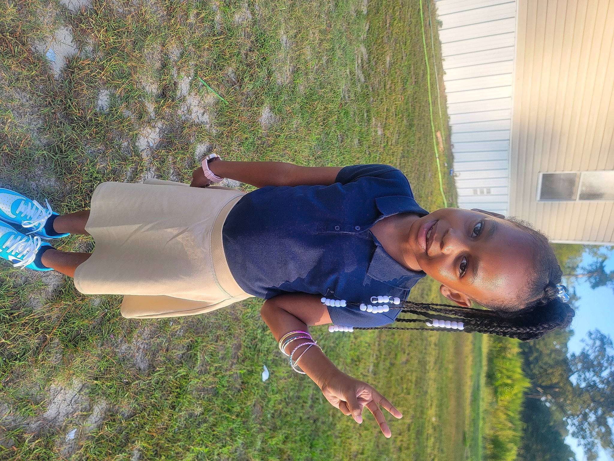 Kinsley is registered to the contest to win money with this photo: elbow, fun, grass, happy, human_leg, joy, leisure, people_in_nature, person, plant, shrub, smile, t_shirt, thigh, toddler, tree, walking_shoe