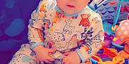 Alina joined the competition — help win amazing prizes! baby, child, onesie, headband, bow, toy, blanket, indoor, cute, infant, playmat, colorful, sitting, face, portrait, expression, animal_print, hand, footwear, soft