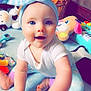 baby, child, blue_eyes, headband, toy, indoor, carpet, smiling, happy, couch, basket, plush_toy, foot, hand, white_shirt, colorful_pants, play, infant, person, room