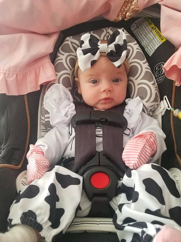 Raelynn is registered to the contest to win money with this photo: baby, baby_carriage, baby_products, baby_safety, baby_toddler_clothing, cheek, child, comfort, eye, eyelash, finger, hand, head, headwear, human_body, outerwear, person, pink, product, skin