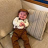 baby, child, smile, couch, pillow, clothing, hat, bow_tie, suspenders, feet, happy, indoor, person, seated, fabric, furniture, cute, infant, portrait, relaxed