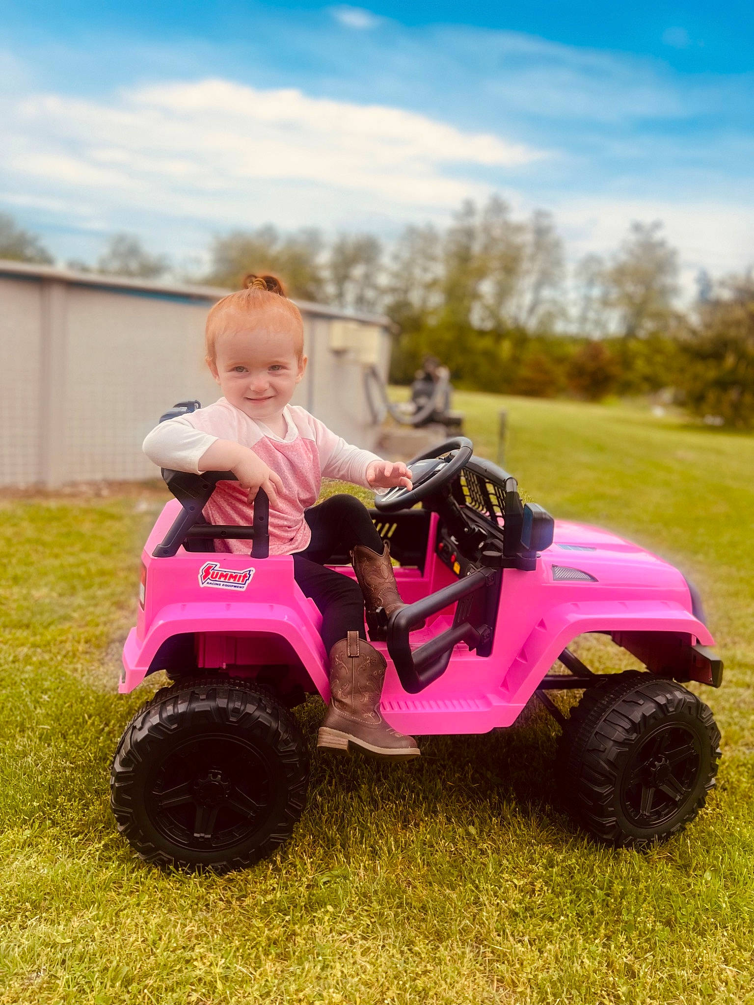 Kaylani is registered to the contest to win money with this photo: automotive_design, automotive_tire, baby_toddler_clothing, car, cloud, face, fender, happy, jeans, joy, land_vehicle, motor_vehicle, people_in_nature, person, plant, riding_toy, sky, t_shirt, tire, tree