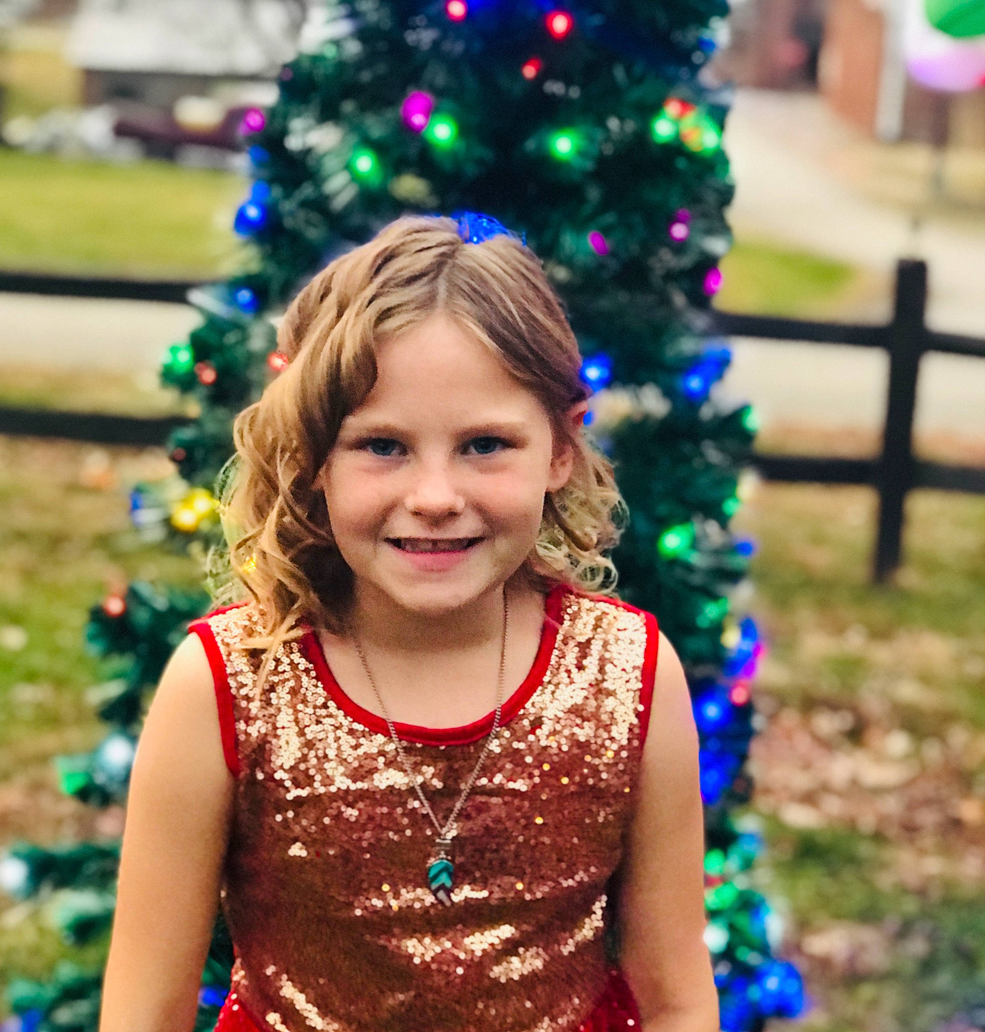 Aleigha is registered to the contest to win money with this photo: beauty, blue, child, christmas_decoration, christmas_ornament, christmas_tree, event, facial_expression, fun, happy, holiday, joy, light, lighting, nature, people, people_in_nature, person, photograph, smile