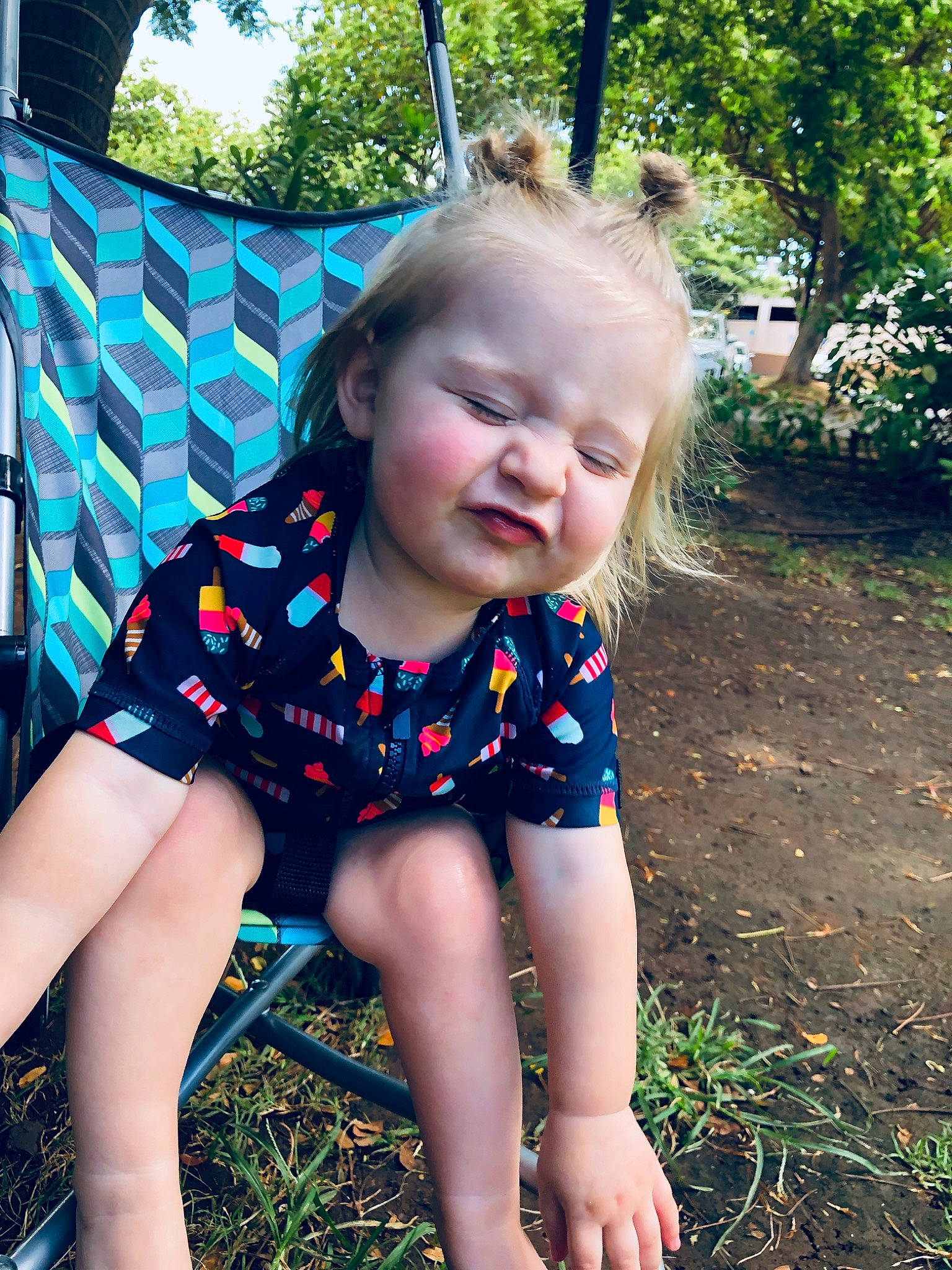 Remy joined the competition — help win amazing prizes! baby, blond, child, design, facial_expression, fun, grass, leaf, leg, pattern, person, play, sitting, skin, smile, spring, summer, sunlight, toddler, tree
