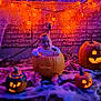 Azul is registered to the contest to win money with this photo: baby, pumpkin, jack_o_lantern, halloween, child, glowing, orange_lights, brick_wall, cobwebs, decorations, outdoor, festive, cute, smiling, costume, holiday, night, seasonal, celebration, sitting
